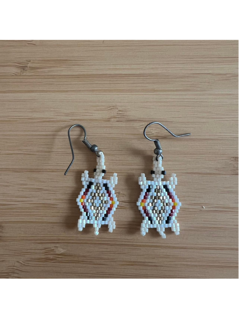 Handmade turtle-shaped beaded earrings with silver hooks